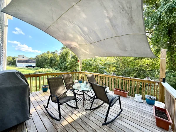 a view of balcony with wooden floor and outdoor seating