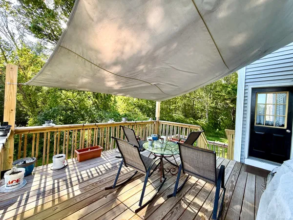 a view of a patio with a table chairs and a yard