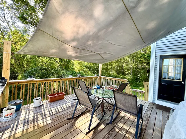 a view of a patio with a table chairs and a yard
