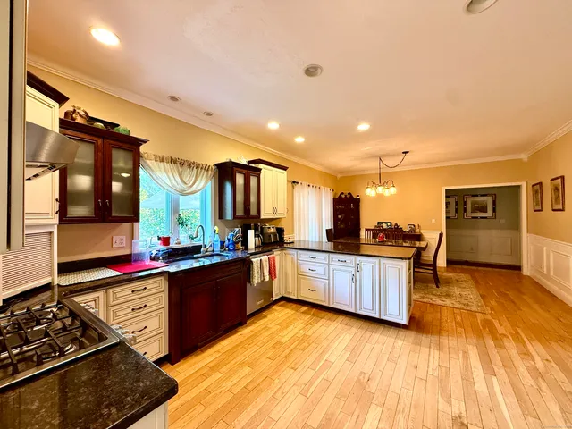 a kitchen with stainless steel appliances granite countertop a stove and cabinets