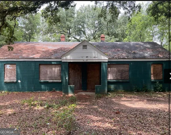 a front view of a house with a yard and a garage