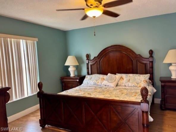 605 Augusta Boulevard, Unit 4 Naples, FL 34113 - Photo 11 of 25 a bedroom with a bed and a chandelier