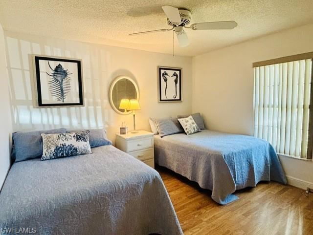 605 Augusta Boulevard, Unit 4 Naples, FL 34113 - Photo 16 of 25 a bedroom with a bed and a painting on the wall