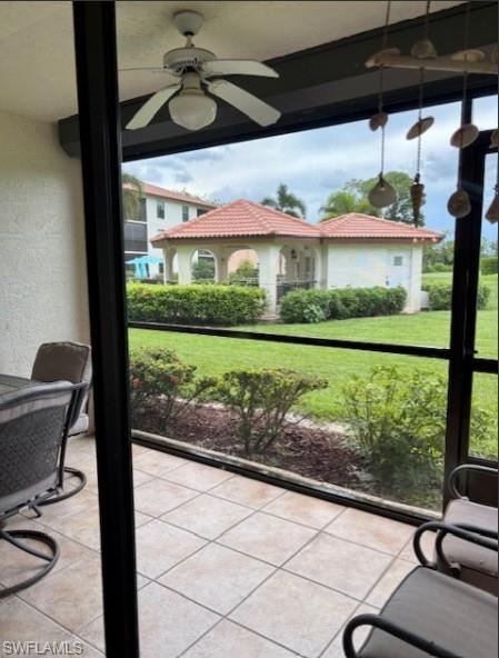 605 Augusta Boulevard, Unit 4 Naples, FL 34113 - Photo 18 of 25 a view of a porch with furniture and a yard