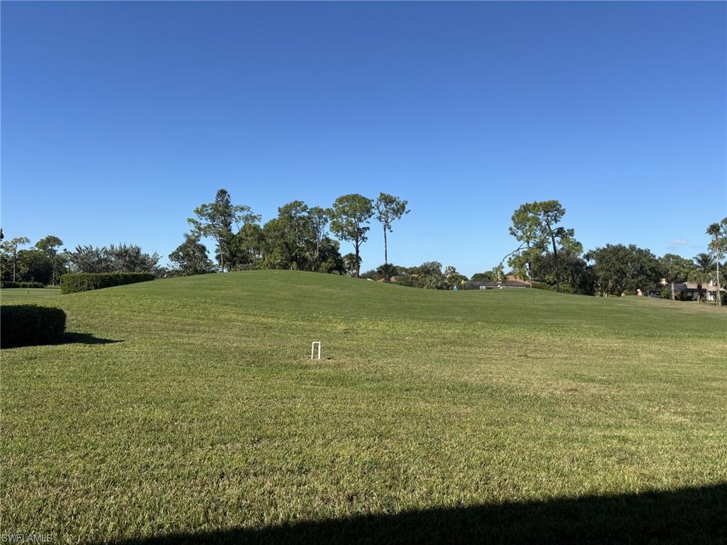 605 Augusta Boulevard, Unit 4 Naples, FL 34113 - Photo 25 of 25 a view of a lake with a big yard