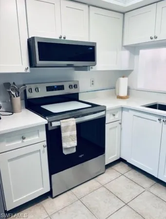 a kitchen with a sink and a stove top oven