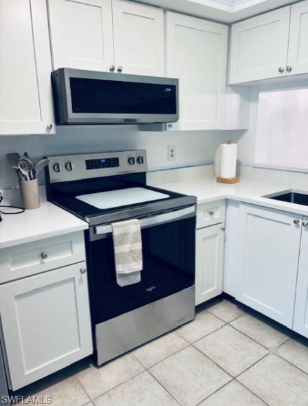 605 Augusta Boulevard, Unit 4 Naples, FL 34113 - Photo 5 of 25 a kitchen with a sink and a stove top oven