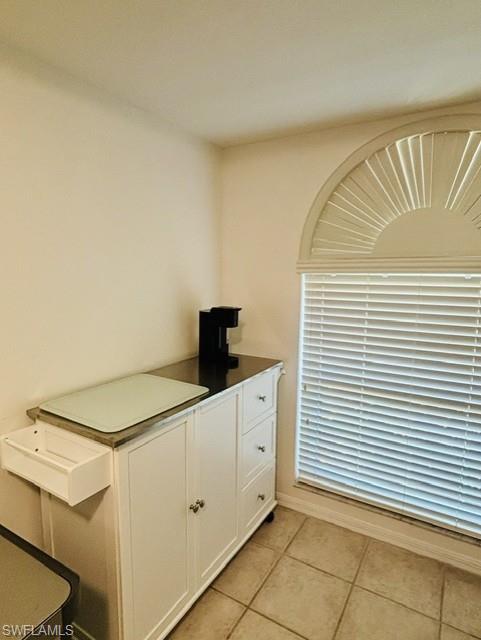 605 Augusta Boulevard, Unit 4 Naples, FL 34113 - Photo 8 of 25 a kitchen with a sink and cabinets