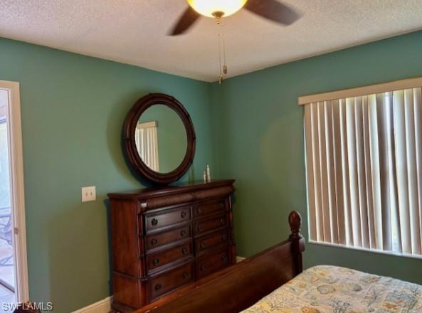 605 Augusta Boulevard, Unit 4 Naples, FL 34113 - Photo 10 of 25 a bedroom with a bed a mirror and a window
