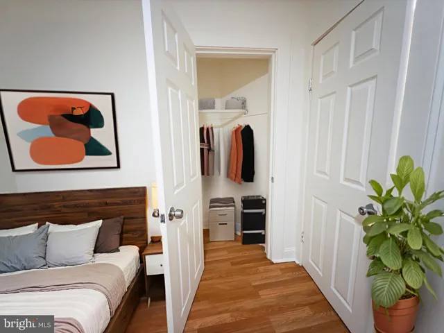 a bedroom with furniture and a potted plant