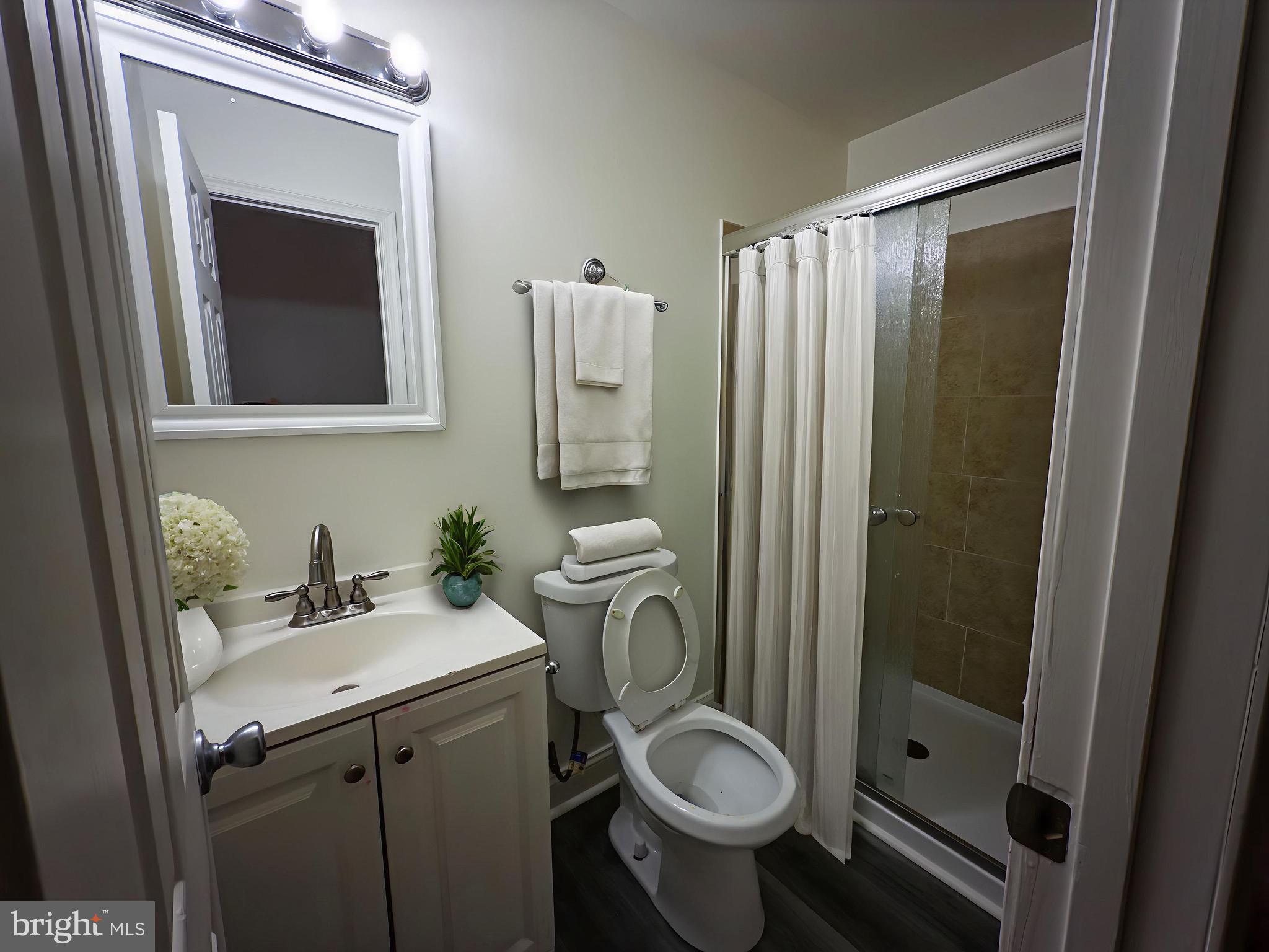 3316 West Belvedere Avenue Baltimore, MD 21215 - Photo 12 of 19 a bathroom with a sink toilet and shower