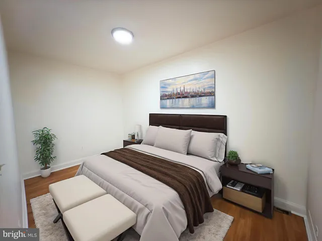 a bedroom with a bed and a potted plant