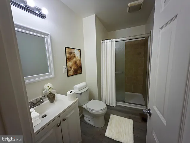 a bathroom with a toilet a sink and shower