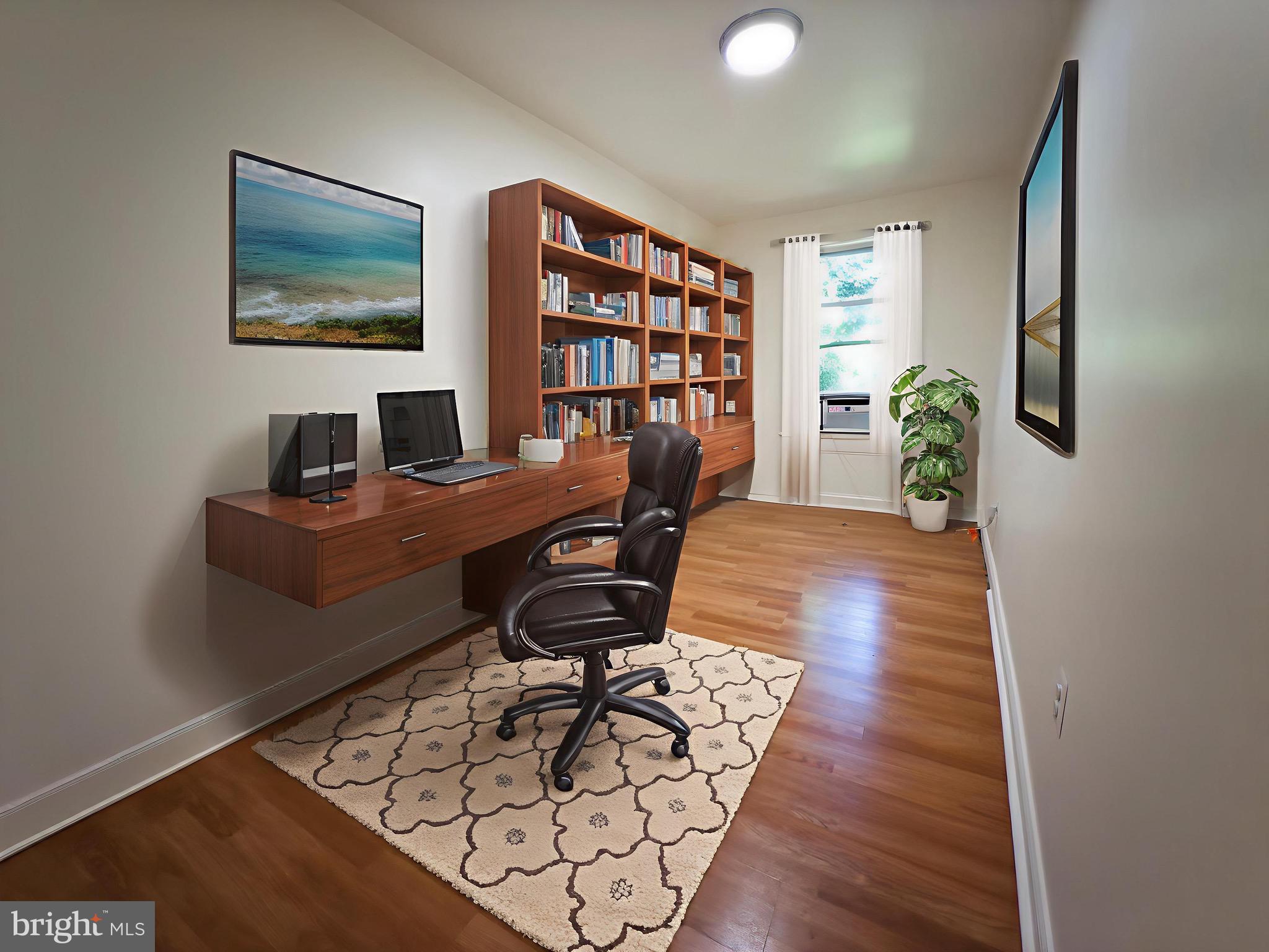 3316 West Belvedere Avenue Baltimore, MD 21215 - Photo 15 of 19 a view of a workspace with furniture and a bookshelf