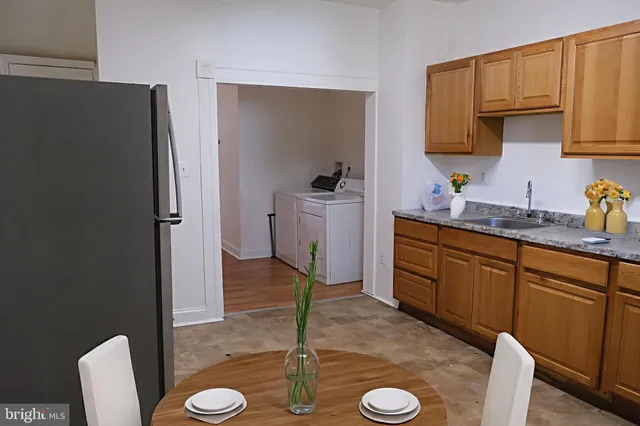 a kitchen with a sink a stove and a refrigerator