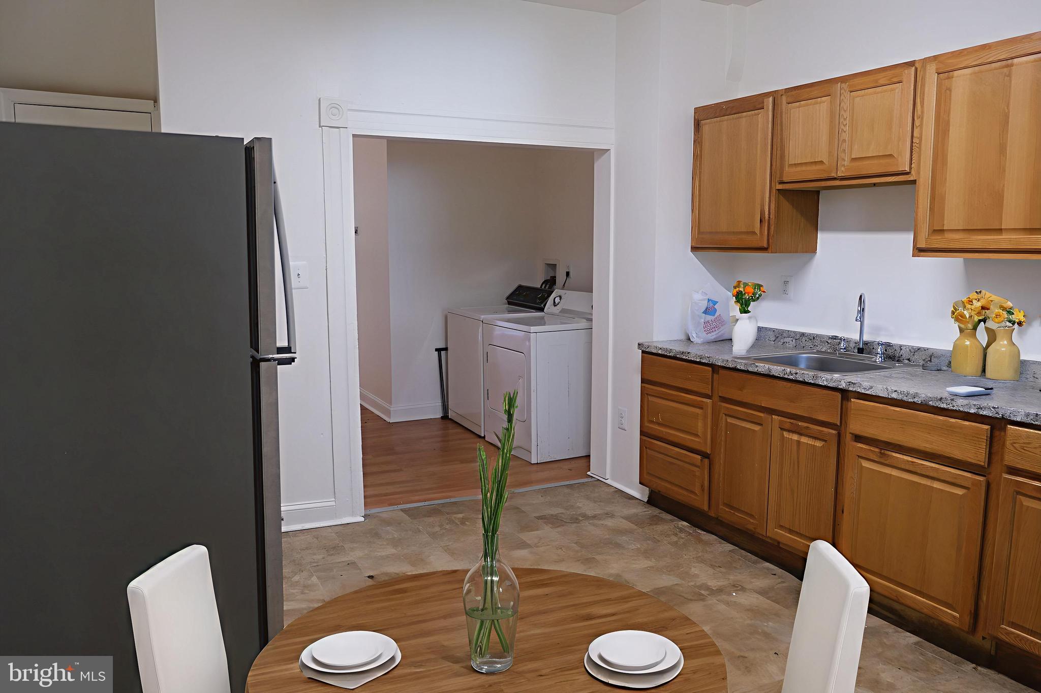3316 West Belvedere Avenue Baltimore, MD 21215 - Photo 4 of 19 a kitchen with a sink a stove and a refrigerator