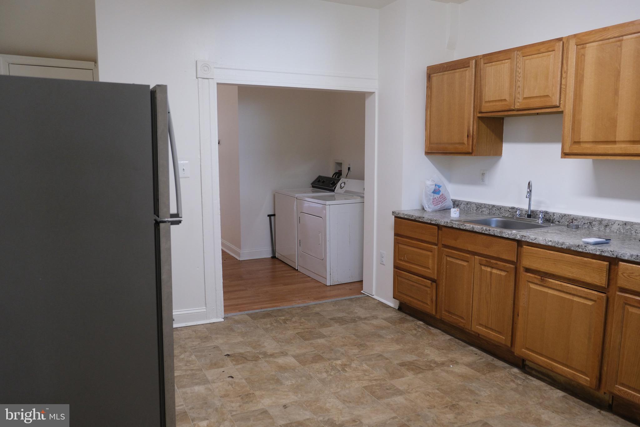 3316 West Belvedere Avenue Baltimore, MD 21215 - Photo 6 of 19 a view of a kitchen with sink electronic appliances and cabinets