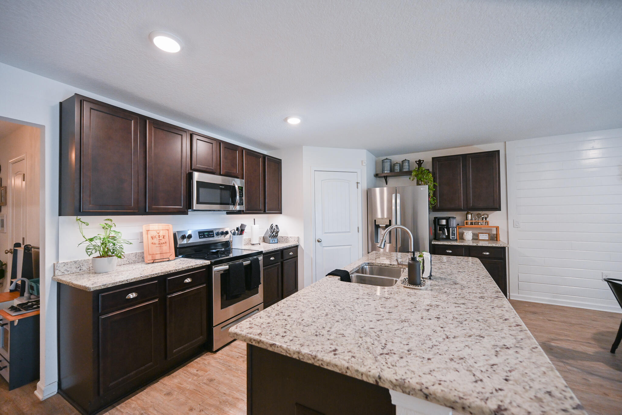 351 Merlin Court Crestview, FL 32539 - Photo 12 of 63 a kitchen with stainless steel appliances granite countertop sink stove refrigerator and cabinets