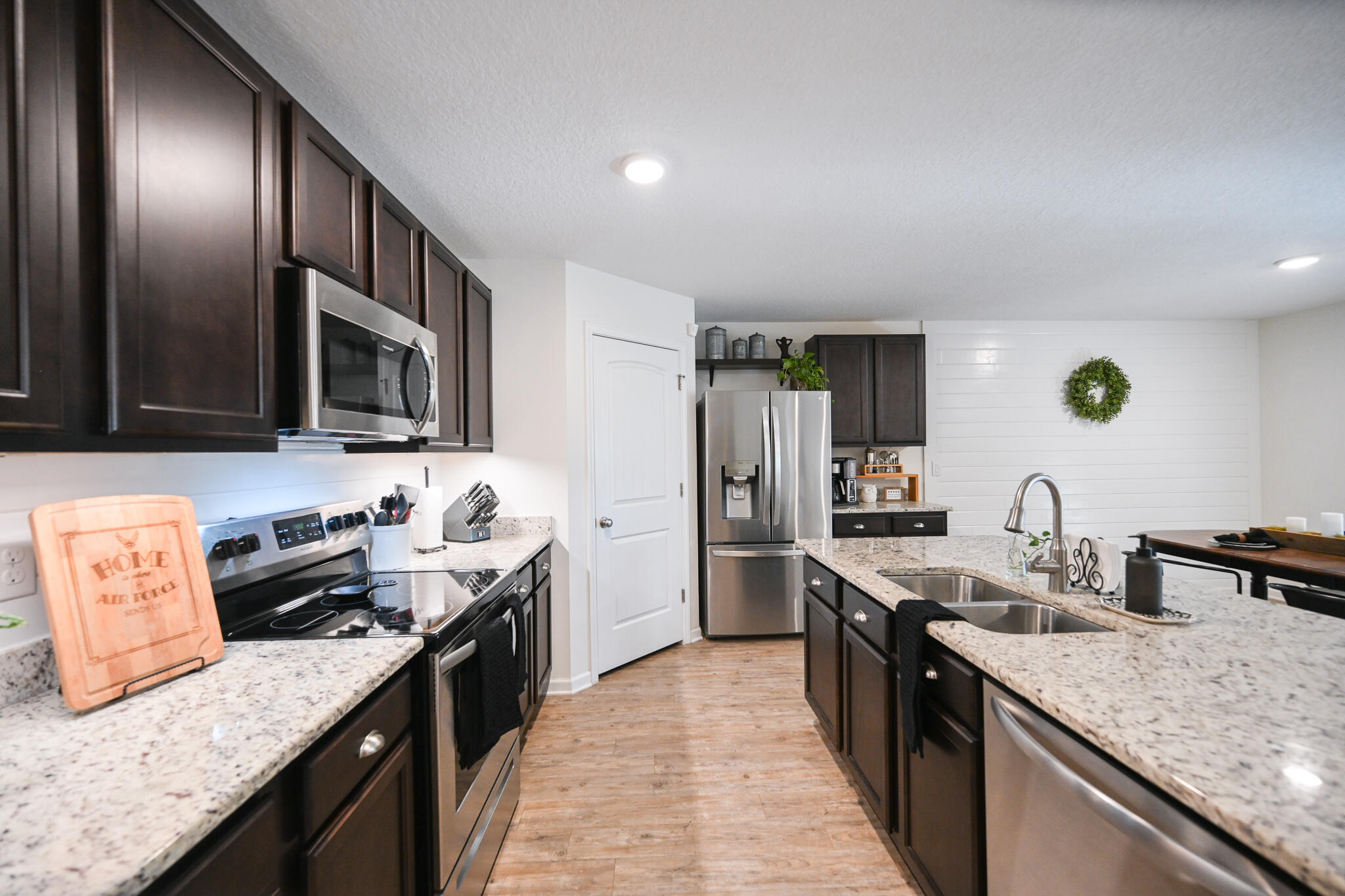 351 Merlin Court Crestview, FL 32539 - Photo 13 of 63 a kitchen with granite countertop stainless steel appliances a sink stove top oven and cabinets
