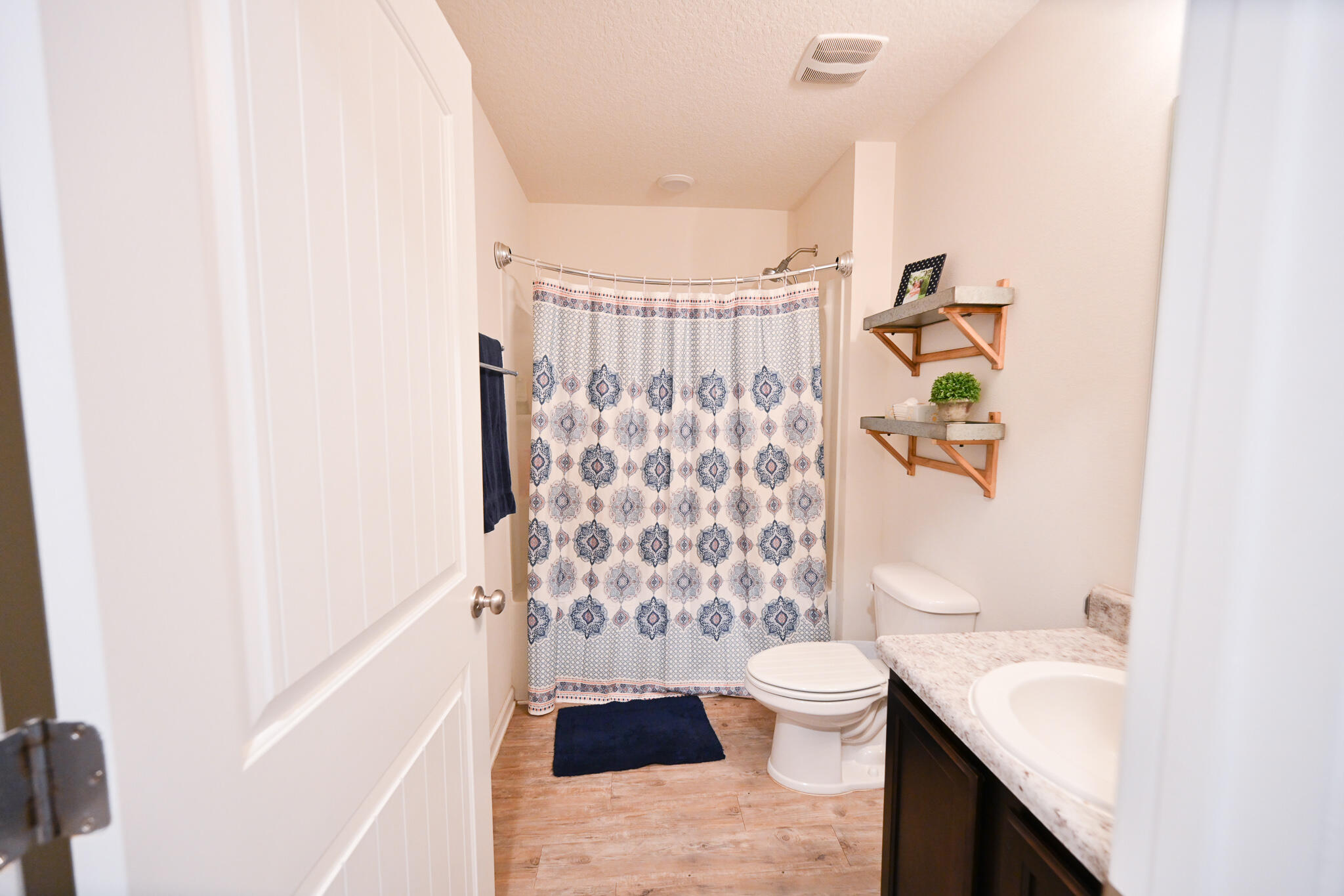 351 Merlin Court Crestview, FL 32539 - Photo 25 of 63 a bathroom with a sink a toilet and shower curtain