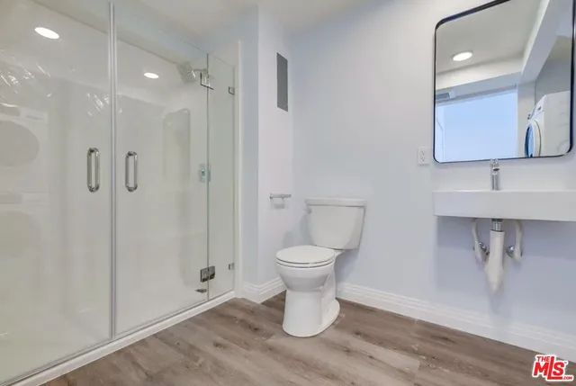 a bathroom with a toilet sink and shower
