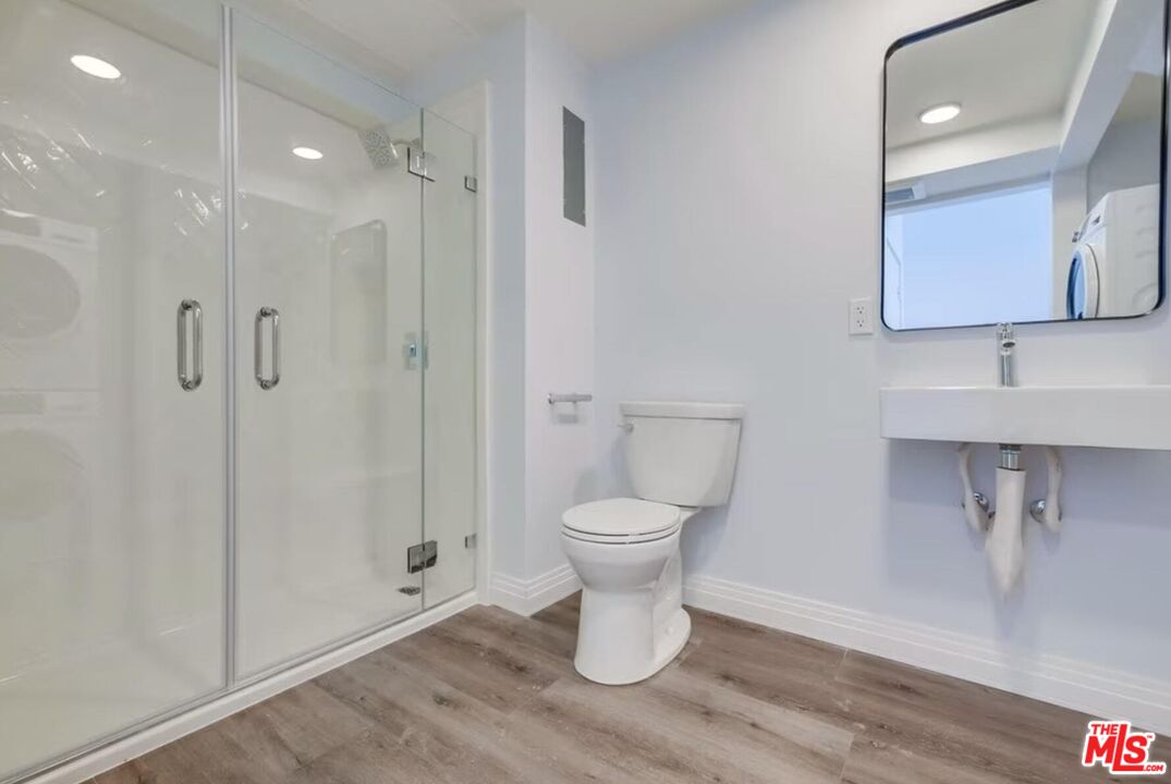 3279 San Marino Street, Unit 407 Los Angeles, CA 90006 - Photo 6 of 8 a bathroom with a toilet sink and shower