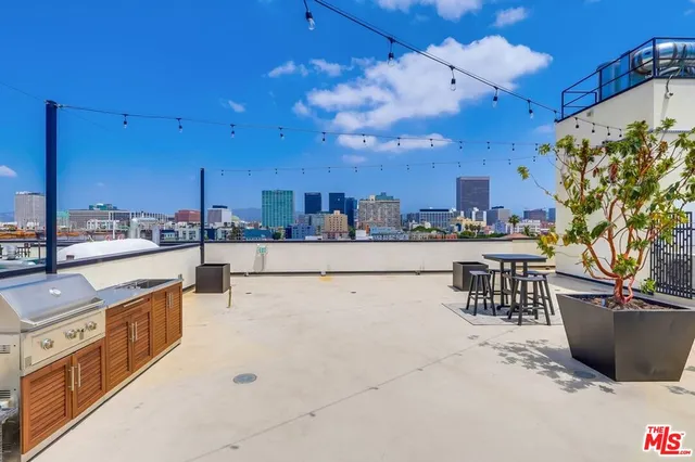 a kitchen with stainless steel appliances kitchen island granite countertop a sink and cabinets
