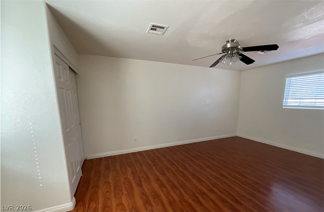 7203 Cestrum Road Las Vegas, NV 89113 - Photo 13 of 22 Warm wood flooring grounds this versatile room featuring a classic multi-panel closet door.