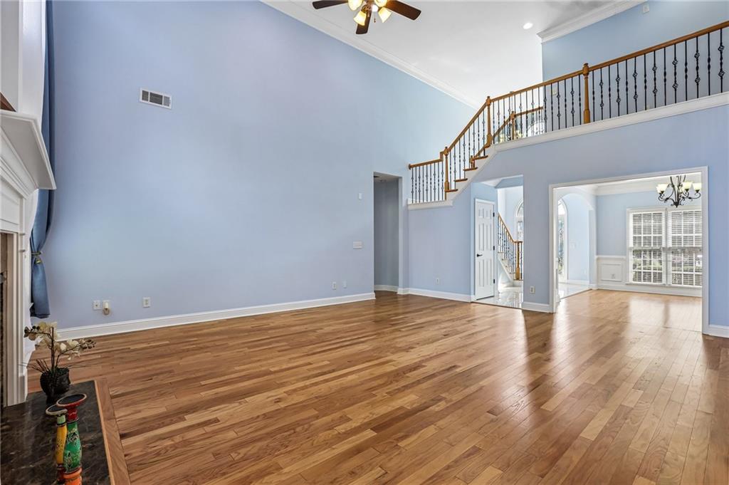 810 Freedom Way Cumming, GA 30040 - Photo 13 of 61 a view of an empty room with wooden floor and a window