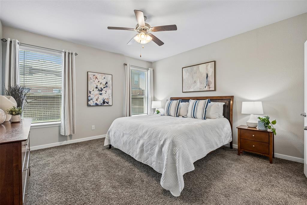 2508 Red Draw Road Fort Worth, TX 76177 - Photo 16 of 38 Neutral wall paint, textured carpet flooring, ceiling fan with light fixture, and two windows with blinds