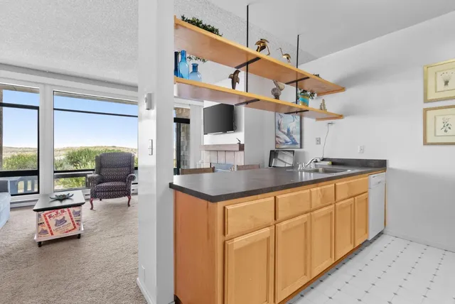 a view of a kitchen with a sink and cabinet
