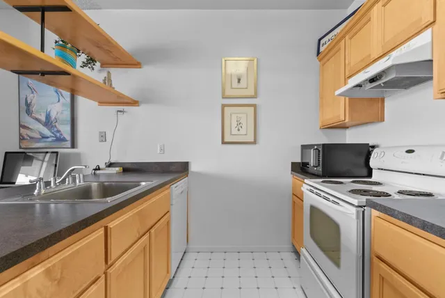 a stove top oven sitting inside of a kitchen