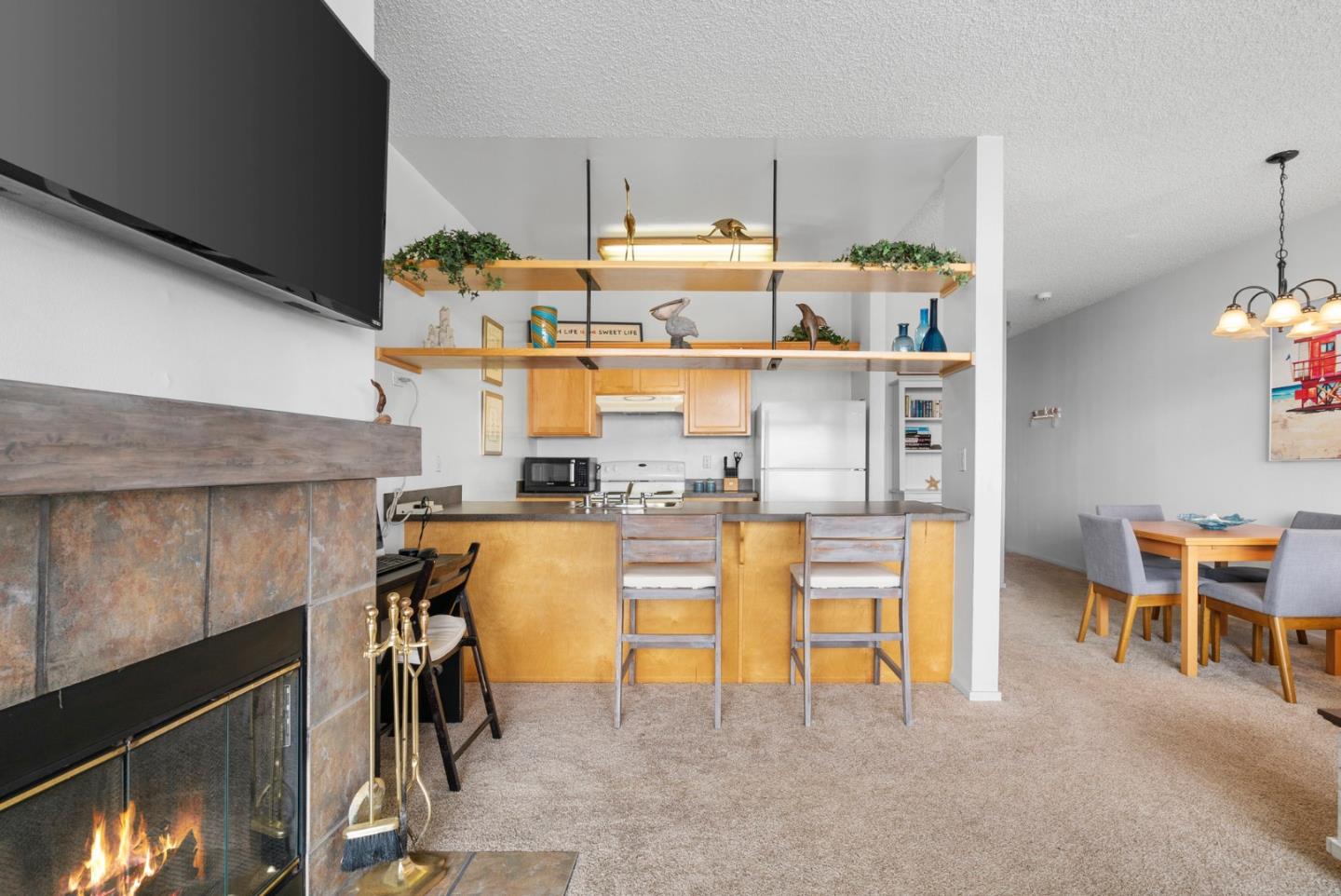 52 Pelican Point Watsonville, CA 95076 - Photo 6 of 36 a kitchen with stainless steel appliances kitchen island granite countertop a table and chairs in it