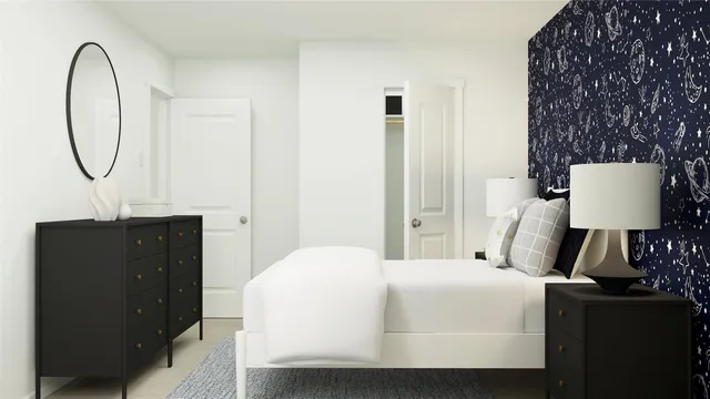 a bedroom with a large bed and a potted plant