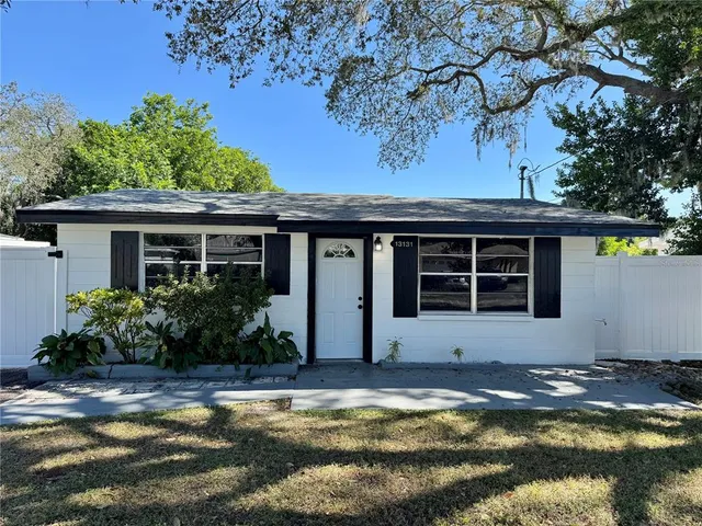 a view of a house with swimming pool and sitting area