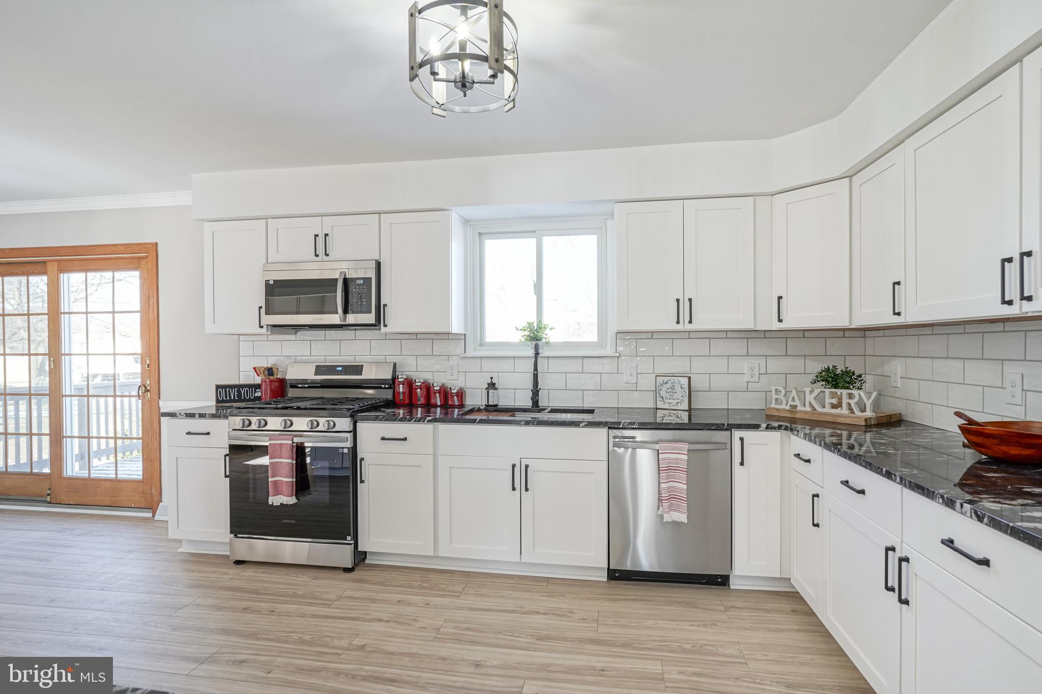 4 North Fork Road Clementon, NJ 08021 - Photo 8 of 37 a kitchen with stainless steel appliances granite countertop a stove top oven a sink dishwasher and a microwave oven on the wooden floor