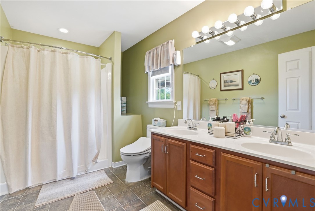 19012 Teman Road Beaverdam, VA 23015 - Photo 20 of 41 a bathroom with a double vanity sink mirror and toilet