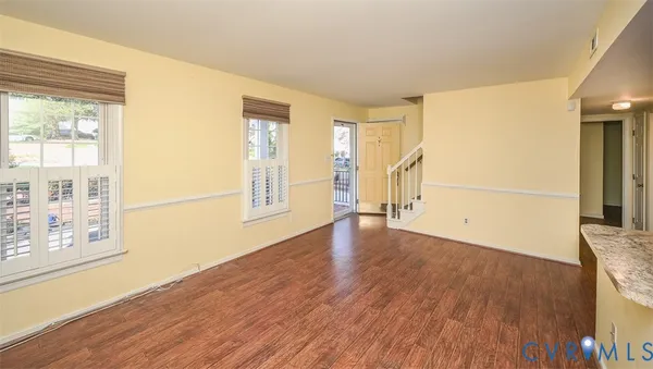 a large kitchen with stainless steel appliances granite countertop a large window a sink and a counter space
