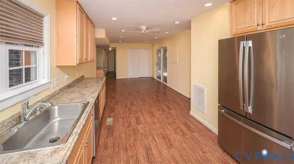 a spacious bedroom with a bed and a flat screen television