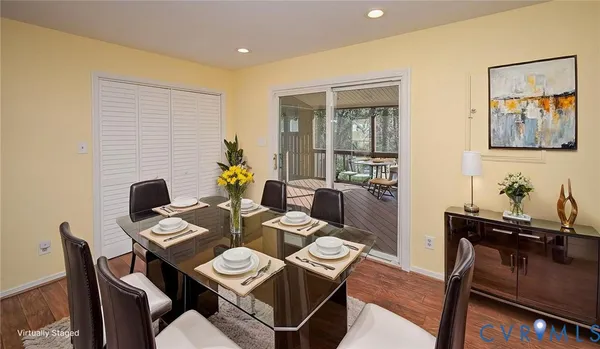 an empty room with wooden floor & closet area