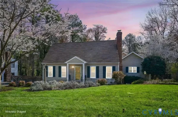 a front view of a house with a garden and yard