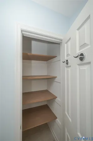 a view of a room with wooden floor and a window
