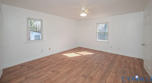 a room with lots of furniture and a ceiling fan