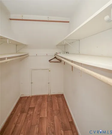 a view of a house with a yard and a large tree