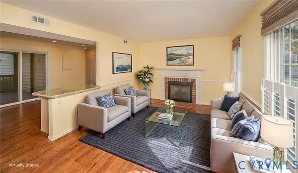 wooden floor fireplace and windows in an empty room