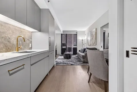 a large white kitchen with cabinets