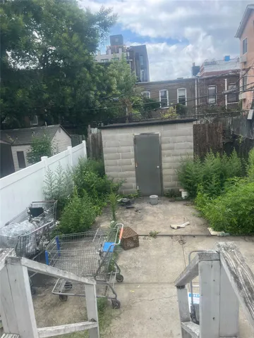 a view of a patio with table and chairs and potted plants