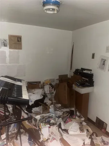 a room with water heater and wooden cabinets