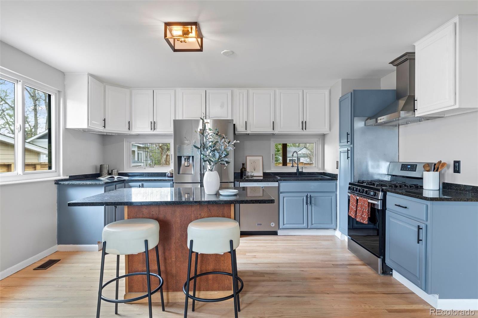 610 East Baseline Road Lafayette, CO 80026 - Photo 6 of 28 a kitchen with stainless steel appliances granite countertop a stove top oven a sink dishwasher and cabinets with wooden floor