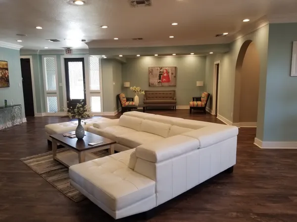 a living room with kitchen island furniture and a chandelier